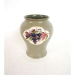 MOORCROFT BALUSTER VASE
the green glazed body with two shaped panels decorated with fruit,