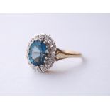 BLUE TOPAZ AND DIAMOND CLUSTER RING
the central oval cut blue topaz in diamond surround,