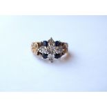 SAPPHIRE AND DIAMOND CLUSTER RING
on nine carat gold shank with decorative floral moulded shoulders,