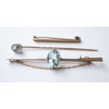 AQUAMARINE SET FIFTEEN CARAT GOLD BAR BROOCH
together with an aquamarine stick pin in unmarked gold,
