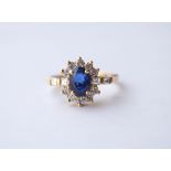 SAPPHIRE AND DIAMOND CLUSTER RING
the oval cut sapphire approximately 1.