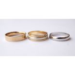 TWO NINE CARAT GOLD WEDDING BANDS
one in white and yellow gold, the other yellow gold,