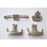 FOUR SILVER GALLEON DECORATED BROOCHES
of varying size and design,