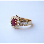 RUBY AND DIAMOND CLUSTER RING
the central oval cut ruby approximately 0.