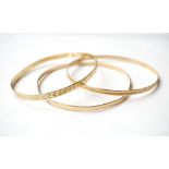 THREE NINE CARAT GOLD BANGLES 
total weight approximately 16.