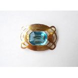 BLUE GEM SET BROOCH
the emerald cut gem stone in nine carat gold pierced mount