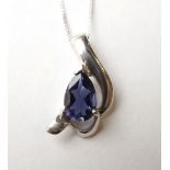 PEAR CUT TANZANITE SINGLE STONE PENDANT
in asymmetrical scrolling nine carat white gold setting,