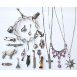 SELECTION OF SILVER AND OTHER CHARMS
including a cricket bat, a stone set seal, a shoe, an anchor,