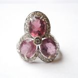 PINK TOURMALINE AND DIAMOND CLUSTER DRESS RING
the three oval cut tourmalines totalling