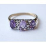 AMETHYST AND DIAMOND RING
the three oval cut graduated amethysts with small diamonds between,