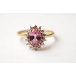 PINK SAPPHIRE AND DIAMOND CLUSTER RING
the oval cut sapphire approximately 1.