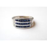 SAPPHIRE AND DIAMOND DRESS RING
the three channel set rows of sapphires flanked by diamonds to each