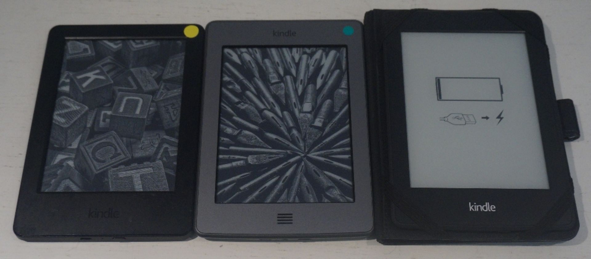 THREE KINDLES
comprising Kindle Basic (2014) serial number 90C6 0606 4367 0232,