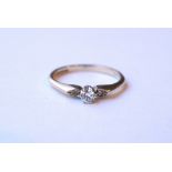 DIAMOND THREE STONE RING
the central round brilliant cut diamond approximately 0.