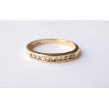 DIAMOND NINE STONE RING
the channel set diamonds in eighteen carat gold shank,