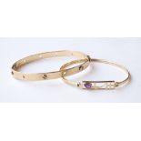 NINE CARAT GOLD MACKINTOSH STYLE BANGLE 
the central pierced section set with amethyst;