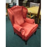 A QUEEN ANNE STYLE WING CHAIR with scrol