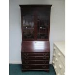 A MAHOGANY BUREAU BOOKCASE the dentil mo