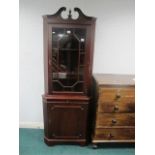 A MAHOGANY CORNER CABINET with astragal