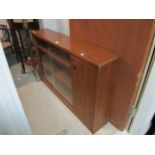 A TEAK BOOKCASE with sliding glazed door