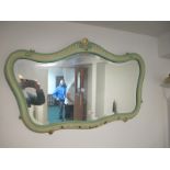 A CONTINENTAL CREAM AND TURQUOISE PAINTED MIRROR the shaped plate within a moulded frame with C