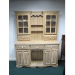 A CONTINENTAL BLEACHED OAK DRESSER of inverted breakfront outline the super structure with glazed