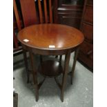 AN EDWARDIAN MAHOGANY OCCASIONAL TABLE of circular outline the shaped moulded top with satinwood