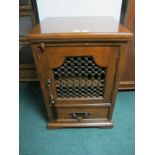 A MEXICAN HARDWOOD SIDE CABINET the rectangular top with grill door and drawer on bracket feet 92cm