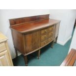 AN EDWARDIAN MAHOGANY SIDEBOARD of demi-lune outline the shaped moulded top above three frieze