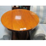 A GOOD ART DECO STYLE WALNUT TABLE of circular outline the shaped moulded top above a carved column