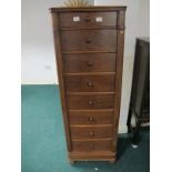 A CONTINENTAL WALNUT WELLINGTON CHEST of rectangular form the shaped moulded top with canted angles