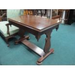 A VICTORIAN MAHOGANY SIDE TABLE the rectangular top above a plain apron on standard end supports