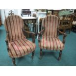 A PAIR OF CONTINENTAL MAHOGANY AND UPHOLSTERED ELBOW CHAIRS each with a rectangular arched back and