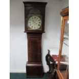 A GEORGIAN MAHOGANY LONG CASE CLOCK the outswept cornice above a rectangular arched glazed door