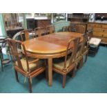 A NINE PIECE ORIENTAL HARDWOOD DINING ROOM SUITE comprising eight chairs including a pair of elbow