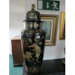 A PAIR OF BLACK LACQUERED AND GILT LIDDED VASES each of baluster form decorated with stylized