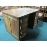 AN OAK PEDESTAL DESK the rectangular top raised on twin four drawer pedestals on platform base 76cm