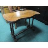 A VICTORIAN MAHOGANY OCCASIONAL TABLE of serpentine outline the shaped moulded top raised on