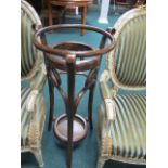 A BENTWOOD WASH STAND of circular form on splayed legs joined by an under tier