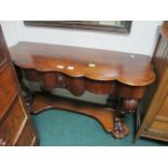 A GOOD VICTORIAN MAHOGANY SIDE TABLE of serpentine outline the shaped moulded top above a frieze