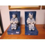 A PAIR OF ORIENTAL BLUE AND WHITE FIGURAL BOOKENDS