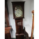 A GEORGIAN MAHOGANY LONG CASE CLOCK the outswept cornice above a rectangular arched glazed door