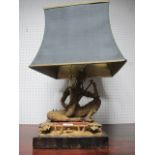 AN ORIENTAL FIGURAL TABLE LAMP with seated female with musical instrument raised on an ebonised