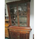 A GEORGIAN MAHOGANY BOOKCASE the outset moulded cornice above a pair of astragal glazed doors the