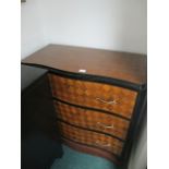 A CONTINENTAL PARQUETRY CHEST of serpentine outline the shaped moulded top above three long drawers