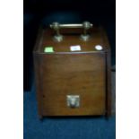 AN EDWARDIAN MAHOGANY AND BRASS SLOPE FRONT FUEL BIN with hinged compartment