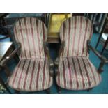 A PAIR OF CONTINENTAL MAHOGANY AND UPHOLSTERED ELBOW CHAIRS each with a rectangular arched back and