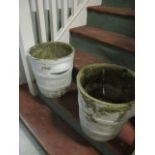 A PAIR OF COMPOSITION SAND STONE PLANTERS each of cylindrical tapering form