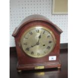 A MAHOGANY CASED MANTLE CLOCK the rectangular arched case with silvered dial and Roman numerals