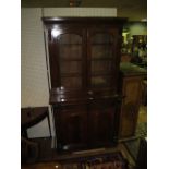 A GOOD VICTORIAN MAHOGANY TWO DOOR LIBRARY BOOKCASE the outset moulded cornice above a pair of